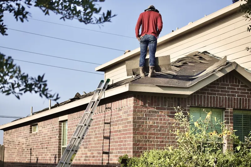 Professional roofer working on a residential roof in Pine Lake Park